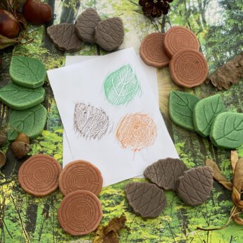 A collection of forest-inspired play stones (leaf, pine cone and log) made from a durable stone mix