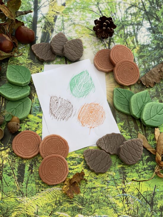 A collection of forest-inspired play stones (leaf, pine cone and log) made from a durable stone mix