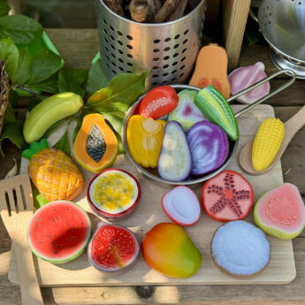 World kitchen food play stones displayed on mud kitchen chopping board