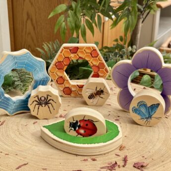 Who's hiding garden bugs wooden puzzles on a table showing Butterfly and flower, Ladybird/bug and leaf, Honeybee and honeycomb, Spider and web